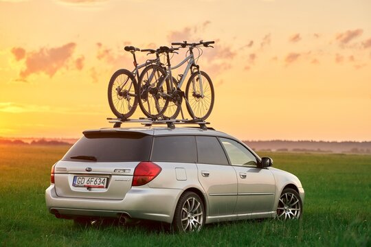 Europe, Poland, Gdansk - August 27, 2023 Car with bikes on the roof mounted with the help of Thule systems. Subaru legacy.