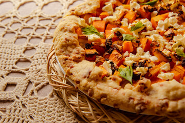 homemade pumpkin galette, open pie on beige knitted tablecloth. fall cozy still life in kitchen