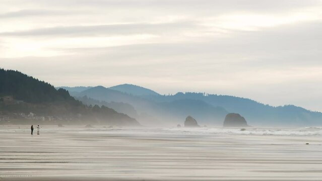Wide footage of beach in coastal town Cannon Beach, Oregon