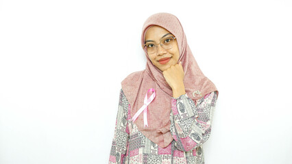 young asian woman patient showing pink badge ribbon chest to support breast cancer cause campaign. 