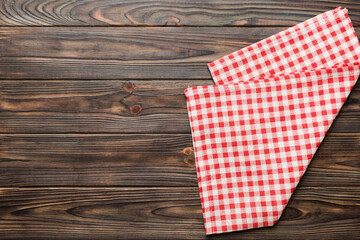 Obraz premium top view with red empty kitchen napkin isolated on table background. Folded cloth for mockup with copy space, Flat lay. Minimal style