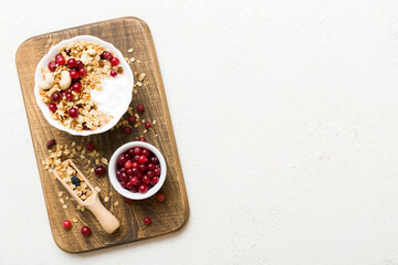 Healthy breakfast food with granola, yogurt, fruits and nuts. Dessert parfait with dried fruits for breakfast