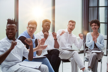 Business people with raised arms during seminar