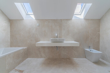 Fototapeta na wymiar Interior photo of modern stylish bathroom with 2 roof windows in beige colors