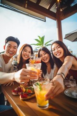 Group of happy friends enjoying cocktails at beach party Travel and summer vacation concept.