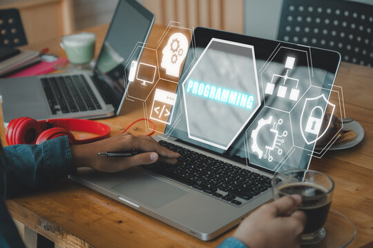 Programming concept, Person working on laptop computer with programming icon on virtual screen.