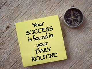 Motivational and inspirational wording. Your SUCCESS is found in your Daily Routine written on a notepad. With blurred styled background.