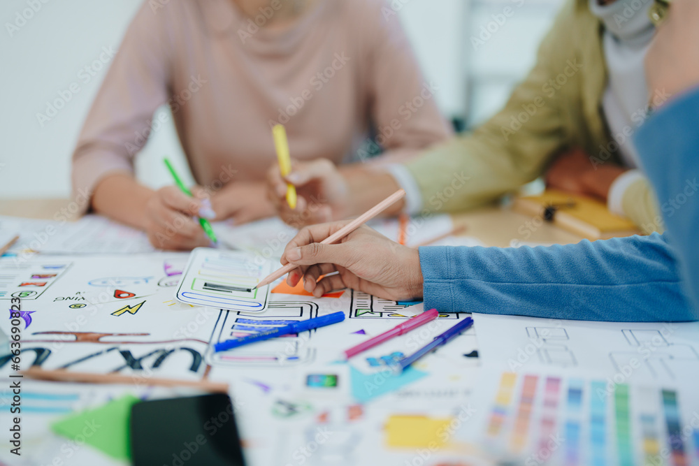Wall mural group of asian creative team programing designers participate in all phases of the ux ui design.