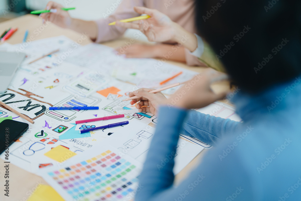 Wall mural group of asian creative team programing designers participate in all phases of the ux ui design.