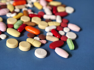 Drug medicine background, pharmaceutical pills and tablets on blue
