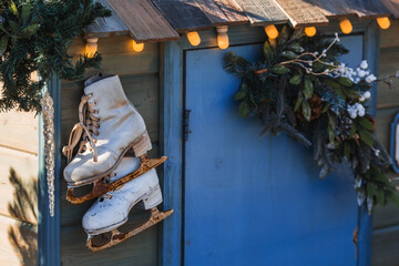 Obraz premium Beautiful holiday decorations. Rusty figure skating skates. Beautiful Christmas background. The concept of decorations and decor for the new year. New Year's card 2024.