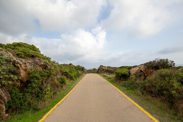 Fototapeta premium road, highway, sky, landscape, asphalt, travel, nature, cloud, summer, rural, line, green, way, field, clouds, street, countryside, mountain, land, horizon, transportation, country, grass, tree, empty