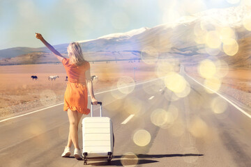 girl walking on the highway with luggage, suitcase travel view from the back, landscape america, hitchhiking concept - obrazy, fototapety, plakaty