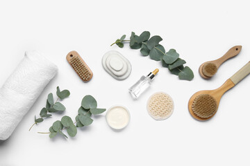 Composition with bath supplies and eucalyptus branches on white background