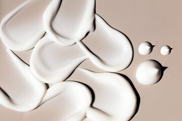 cosmetic smears of creamy texture on a beige background - obrazy, fototapety, plakaty