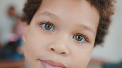 Close up portrait little African American boy smile posing looking at camera. Joyful African American little cute boy student. Pupil concept. Back to school concept