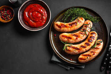 Grilled sausages with sauce and herbs