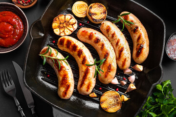 Grilled sausages with sauce and herbs