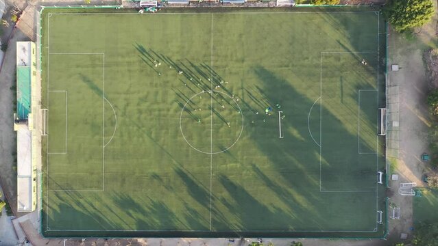 Aerial view of soccer players on the field at day approaching