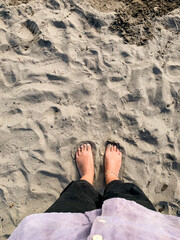 barefoot step on the sand, grounding concept.