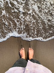 barefoot and waves on the beach, grounding concept.