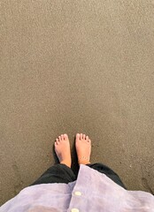 barefoot on the sand, grounding concept.