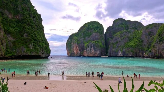 Phi Phi island off the coast of phuket thailand. Phi phi island is famous for turquoise clear blue waters teaming with Corel reef fish white soft sand and lush green trees.