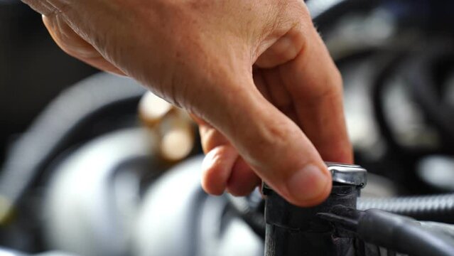 Hand opens the radiator water tank in the car engine. To check the Car radiator
