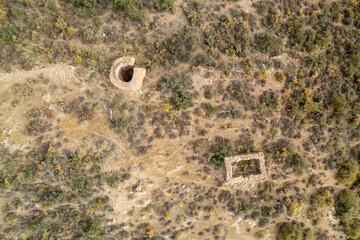 overhead photo of several ruined buildings in the mountain