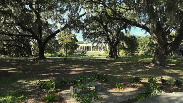 Droning by a water fountain and approaching pavilion at City Park in New Orleans
