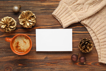 Beautiful Christmas composition with greeting card, decor and cup of coffee on wooden background