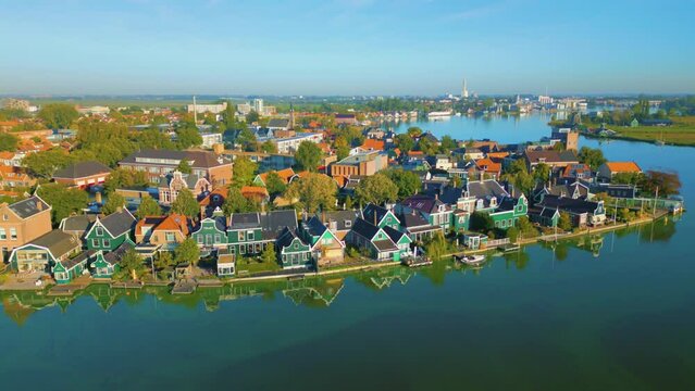 Old traditional wooden houses along the river at the Zaanse Schans, Koog aan de Zaan, Netherlands. High quality 4k footage