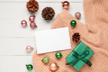 Beautiful Christmas composition with blank card, gift box and decor on white wooden background
