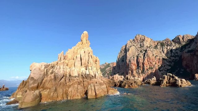 Stunning footage of Calanques de Piana rock formations in Corsica, France, as seen from tour boat on Mediterranean Sea in summer season