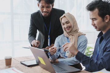 Group of young Asian business people talk, consult, discuss working with new startup project idea presentation analyze plan marketing and investment.