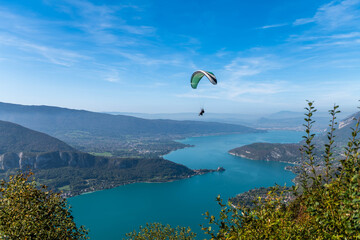 Paragliders above Lake Annecy, in autumn, in Haute Savoie, France - 663734214