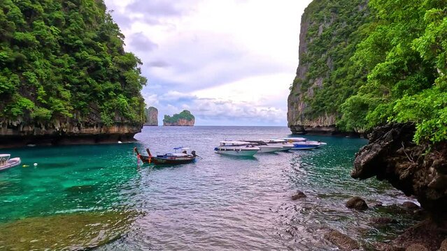 Phi Phi island off the coast of phuket thailand. Phi phi island is famous for turquoise clear blue waters teaming with Corel reef fish white soft sand and lush green trees.