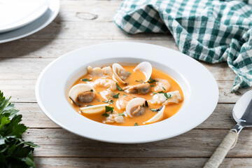 Seafood soup on wooden table