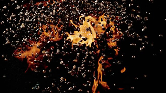 The coffee beans shoot into the air with fire below it
