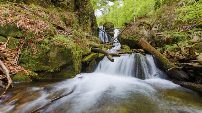 waterfall on the stream among boulders. nature scenery in carpathian woods