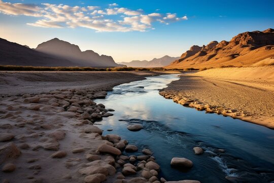 A river flowing through a desert with mountains in the backdrop and a river crossing the middle of the desert. Generative AI