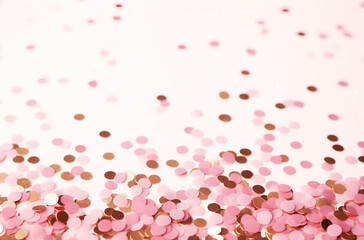 Obraz na płótnie Canvas pink and bronze confetti on a surface
