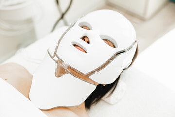 photon mask. Health and beauty. Cosmetic procedure for a woman's face. LED face mask, photon therapy.