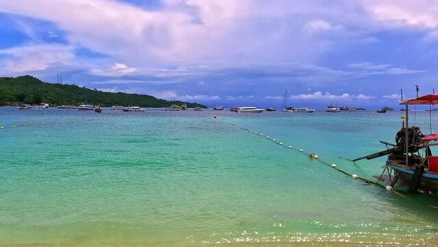 Phi Phi island off the coast of phuket thailand. Phi phi island is famous for turquoise clear blue waters teaming with Corel reef fish white soft sand and lush green trees.
