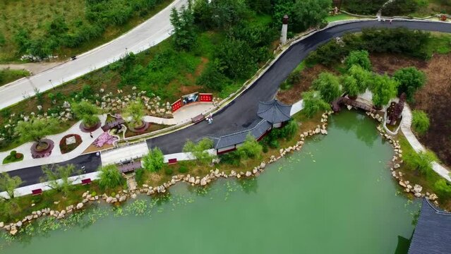 Complete 360 loopable aerial panoramic view over Huaxiacheng park with beautiful traditional buildings in Weihai city, China