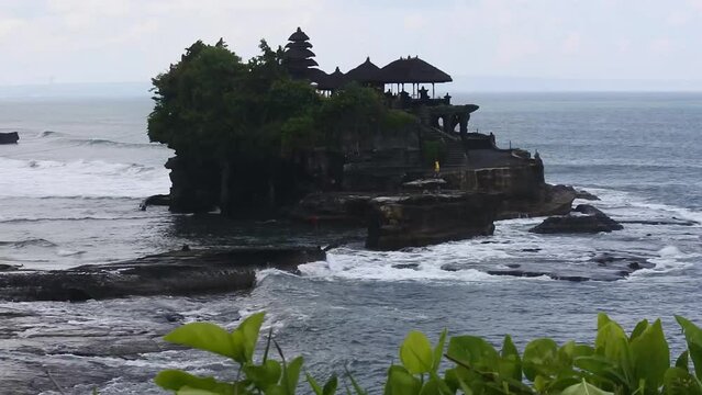 View of Tanah Lot in Tabanan, Bali, Indonesia. Popular tourist attraction and cultural icon. It houses the ancient Hindu pilgrimage temple Pura Tanah Lot.