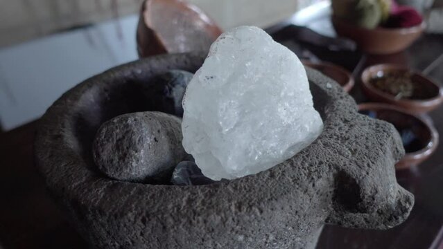 Close-up shot of a large rock of salt in a pestle and mortar
