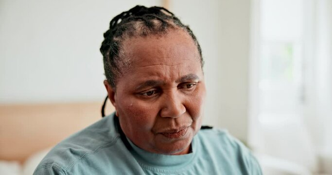 Senior African woman, sad and thinking in retirement with grief, mental health and remember regret in bedroom. Elderly lady, anxiety and depression with bad memory, ideas and worry in nursing home