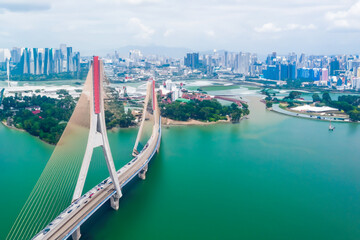 a big red bridge standing over a river and a big city. AI GENERATE - obrazy, fototapety, plakaty