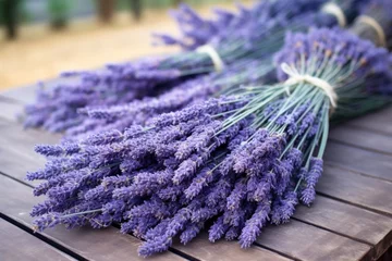 Tuinposter close-up of dried lavender bunches on a table © altitudevisual